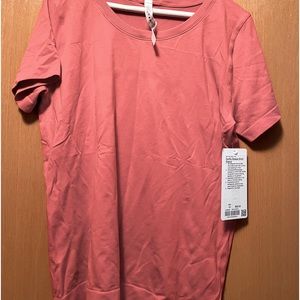 Lululemon swiftly breeze short sleeve top in a muted orange color.